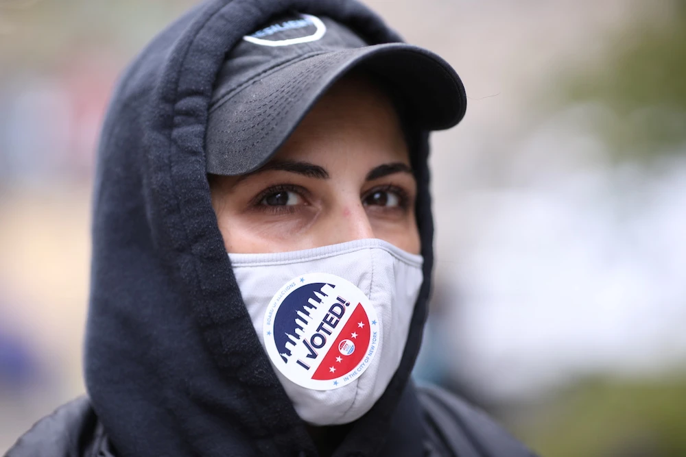 A woman wears a sticker “I voted!” on her protective mask at the Atlantic Terminal Senior Citizen Center on the Election Day in New York, US, Nov. 3, 2020. (Reuters)