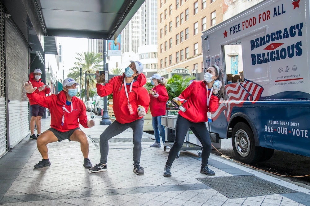 Food truck staff stands in front of Pizza to the Polls and Uber Eats food truck on Election Day, Tuesday, Nov. 3, 2020, in Miami. (AP Images for Pizza to the Polls)