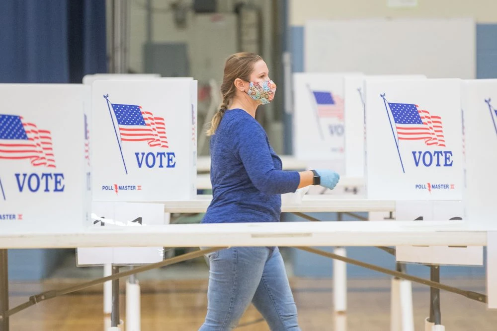 An election worker moves between voting booths at a polling location on Nov. 3, 2020 in Hermon, Maine. (Getty Images/AFP)