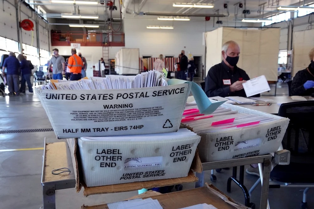 Election officials begin counting absentee ballots at City Hall on Nov. 03, 2020 in Beloit, Wisconsin. Wisconsin requires election officials to wait to begin counting these votes until after polls open on election day. (Getty Images/AFP)