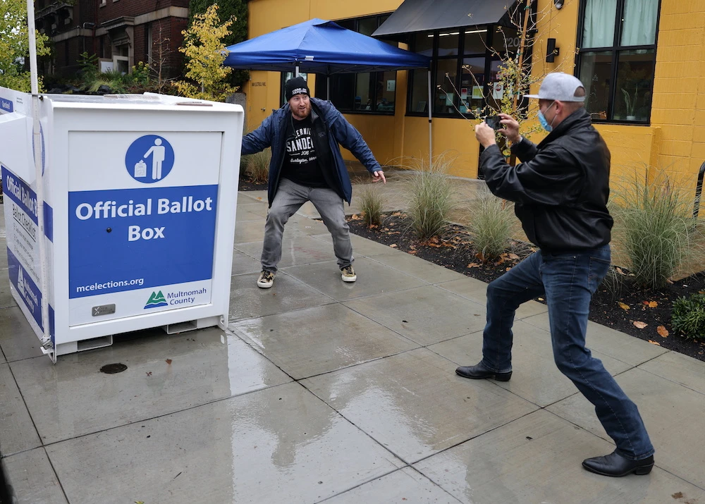 A man poses for photographs as he votes during the 2020 US presidential elections in Portland, Oregon, US, Nov. 3, 2020. (Reuters)