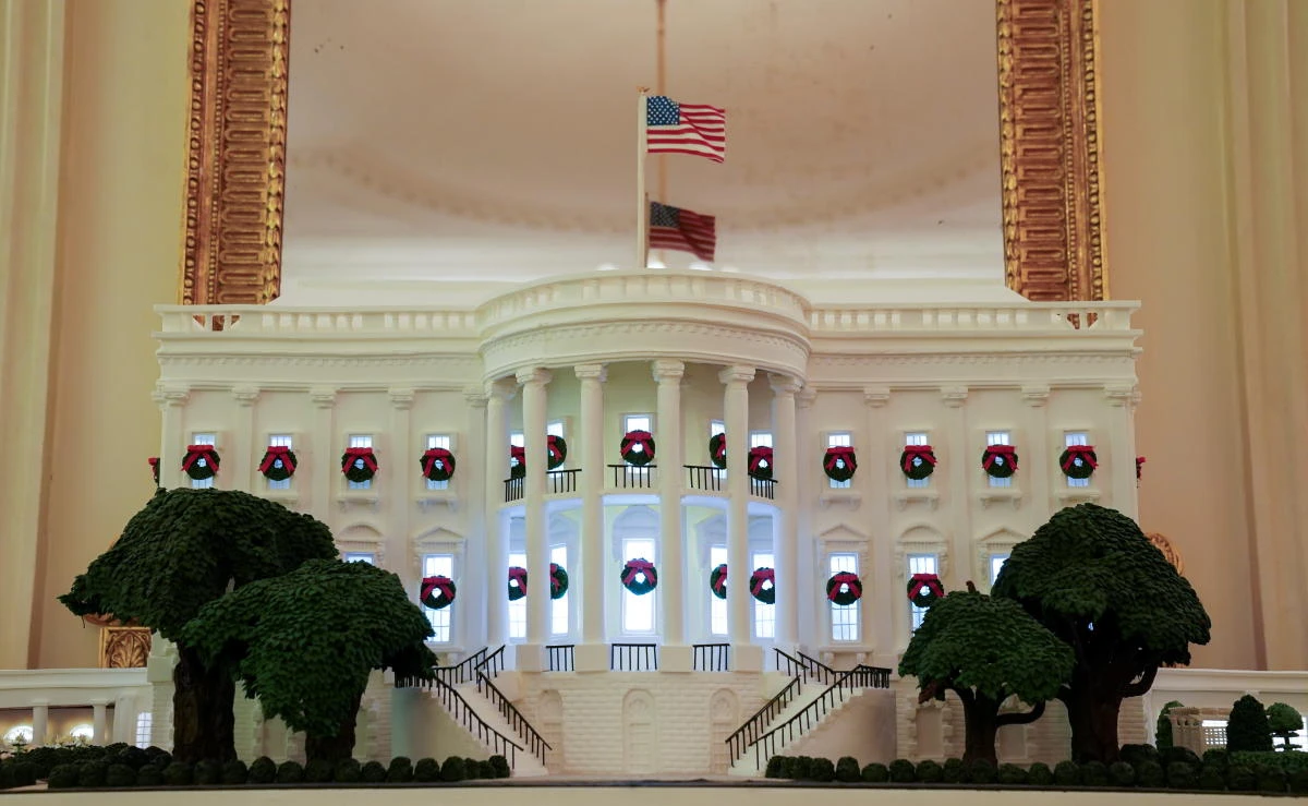 A gingerbread White House adorns the State Dining Room during a holiday decoration press preview at the White House in Washington, U.S., November 30, 2020. REUTERS/Kevin Lamarque