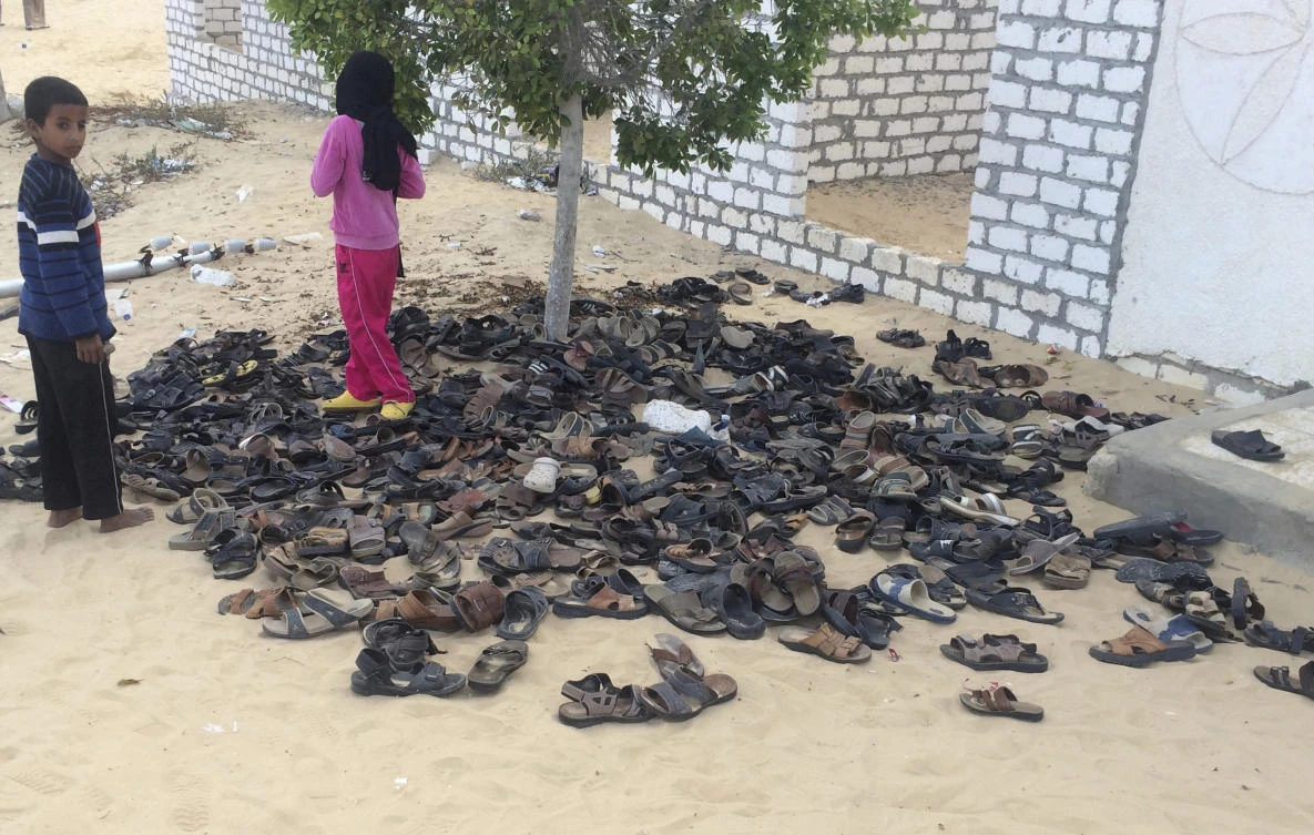 Discarded shoes of victims remain outside Al-Rawda Mosque in Bir al-Abd northern Sinai, Egypt. a day after attackers killed hundreds of worshippers, on Saturday, Nov. 25, 2017. (AP Photo)