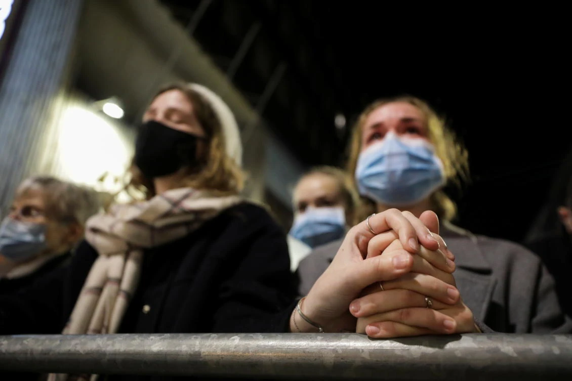 People listen from the street during a mass at Notre Dame basilica to pay tribute to the victims of a deadly knife attack in Nice, France, November 1, 2020. (Reuters)