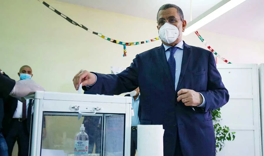 Algerian Prime Minister Abdelaziz Djerad casts his ballot at a polling station in the capital Algiers, during a vote for a revised constitution, on Sunday. (AFP)