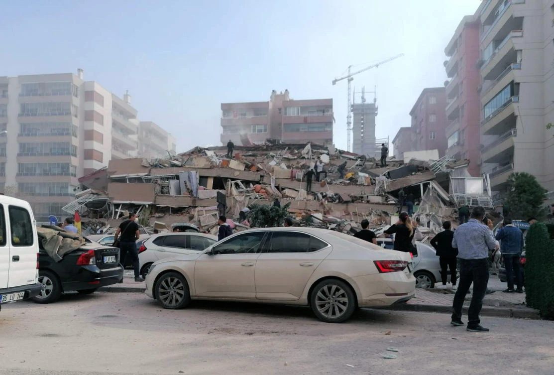 People work on a collapsed building, in Izmir, Turkey, Friday, Oct. 30, 2020, after a strong earthquake in the Aegean Sea has shaken Turkey and Greece. (AP)