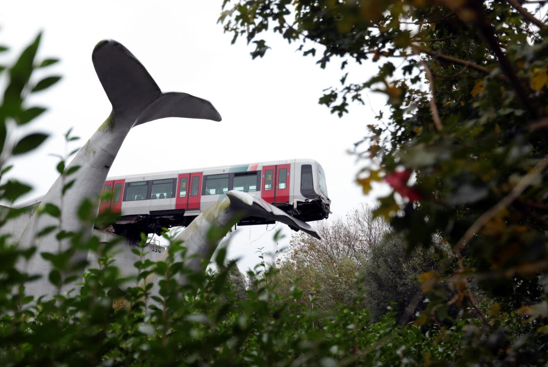 A general view of a metro that crashed through a stop block and landed on an artwork of a whale tail at De Akkers subway station in Spijkenisse, near Roterdam, Netherlands, November 2, 2020. (Reuters)