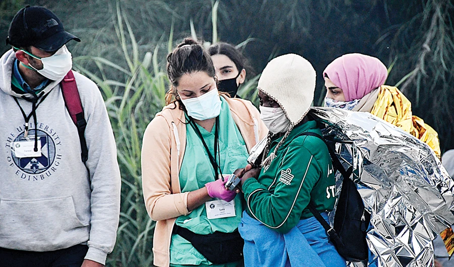A migrant is treated after a fire broke out at a refugee and migrant camp, on the Greek island of Samos, on Monday. (AP)