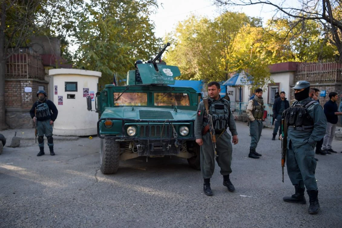 Policemen stand guard at an entrance of the Kabul university a day after gunmen stormed the university in Kabul on November 3, 2020. (AFP)