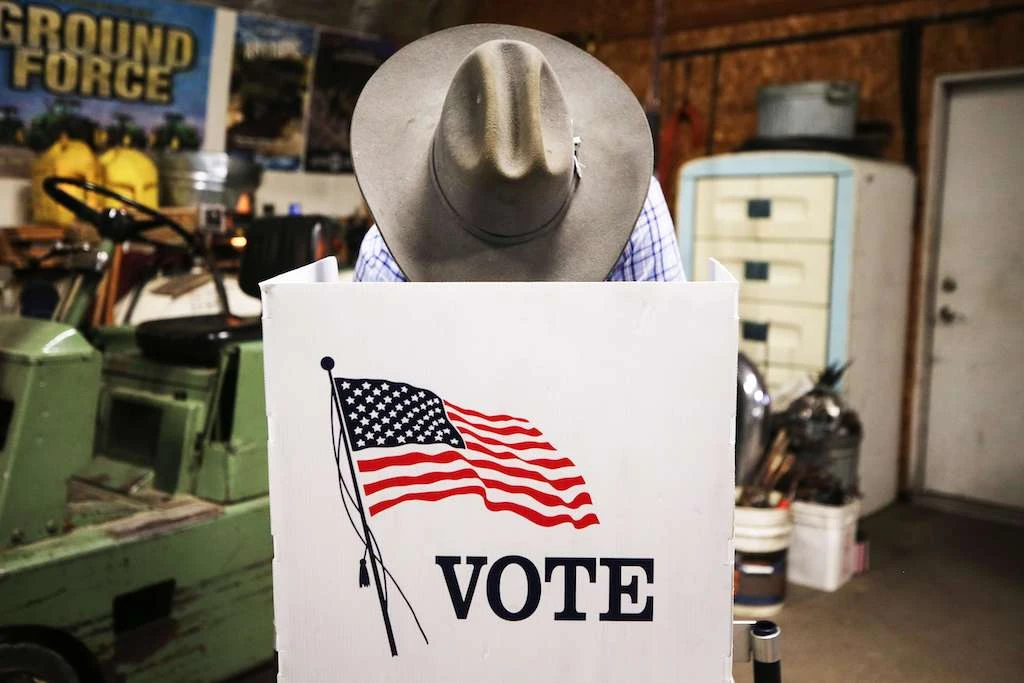 A voter marks his ballot at a polling place in Dennis Wilkening's shed on November 3, 2020 in Richland, Iowa. (AFP)