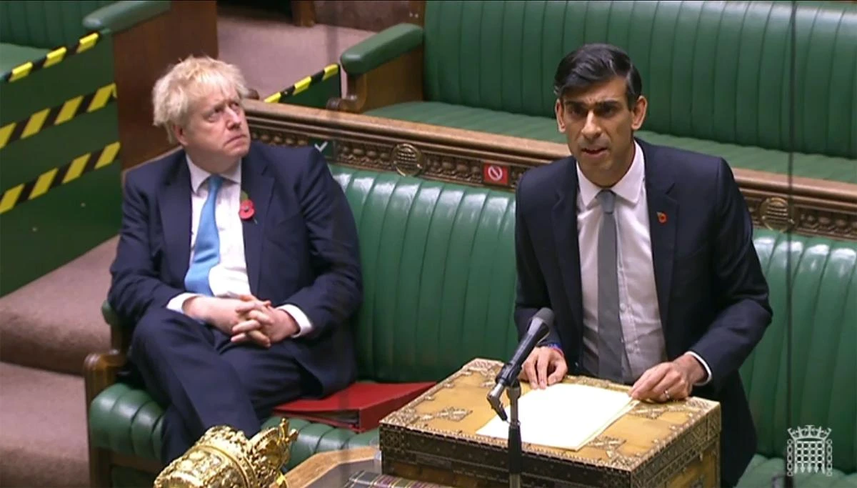 Britain's Prime Minister Boris Johnson listens as Britain's Chancellor of the Exchequer Rishi Sunak gives an update of the economy in the House of Commons in London on November 5, 2020. (AFP)