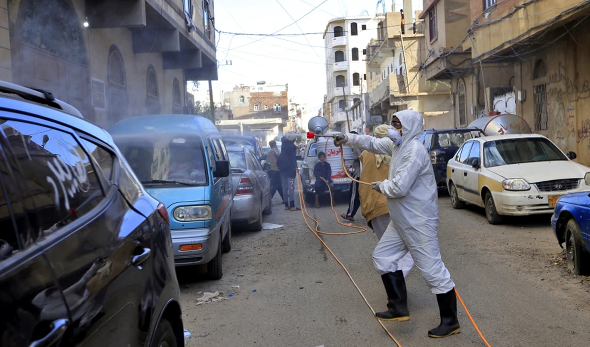 Yemeni workers spray disinfectant in a neighborhood of the capital Sanaa. (AFP)