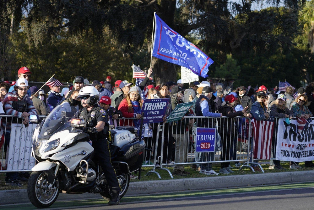 Supporters of the re-election of Donald Trump demonstrate on North Santa Monica Blvd., in Beverly Hills, California on Nov. 7, 2020, demanding a recount of votes as news of supporters of Joe Biden celebrate his victory. (AP Photo/Damian Dovarganes)
