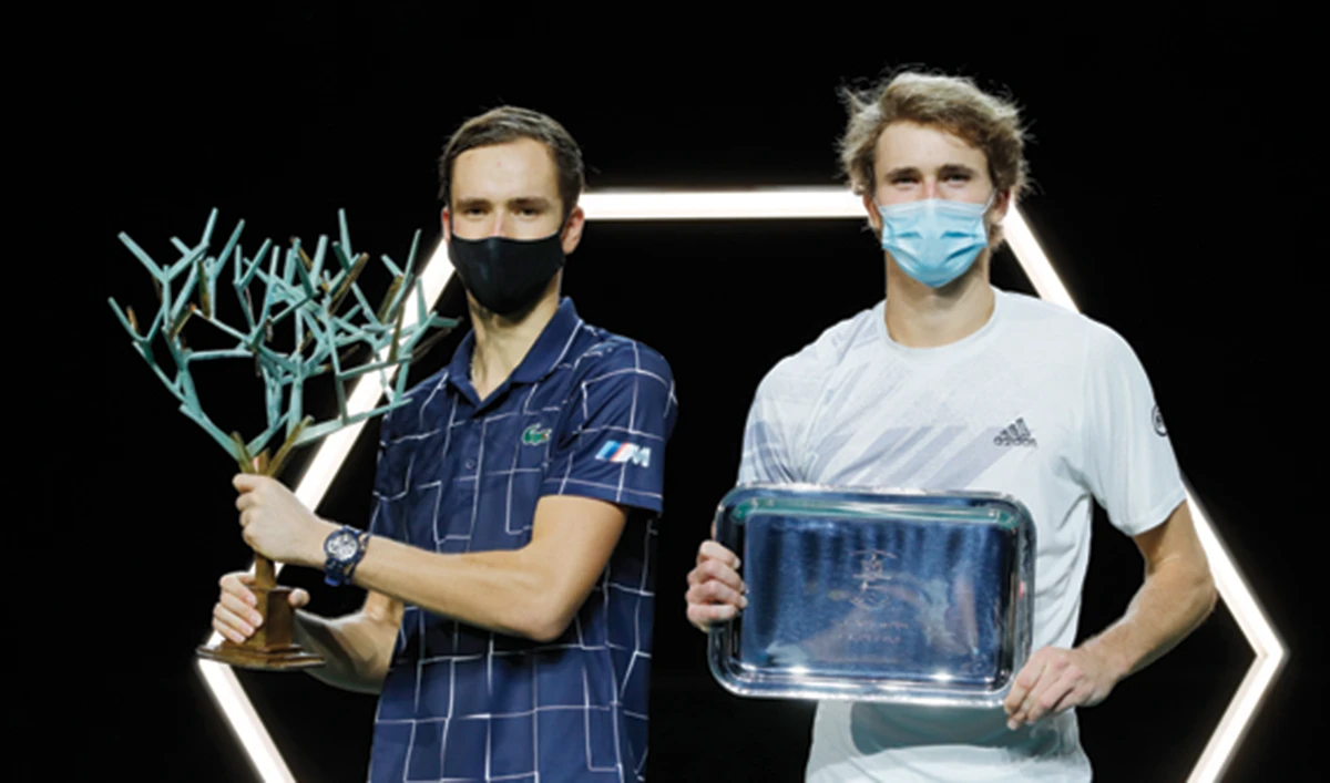 Alexander Zverev, right, and Daniil Medvedev hold their trophies after the Paris Masters tennis tournament final. (AP)