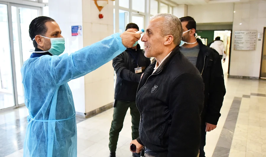 A Lebanese medic takes the temperature of a suspected coronavirus case. (File/AFP)