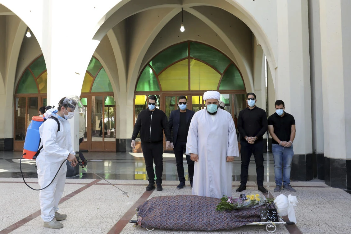 At Behesht-e-Zahra or Zahra’s Paradise in Farsi, named after a daughter of the Prophet Muhammad, the bodies of known coronavirus victims arrive each day by ambulance. Mortuary attendants prepare each body for the ritual washing required for the Muslim dead. (AP Photo/Ebrahim Noroozi)
