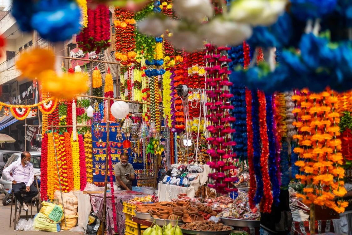 Vendors selling decorations for Diwali, the Hindu Festival of Lights, wait for customers at their stalls in a market area in New Delhi on November 14, 2020. (AFP)