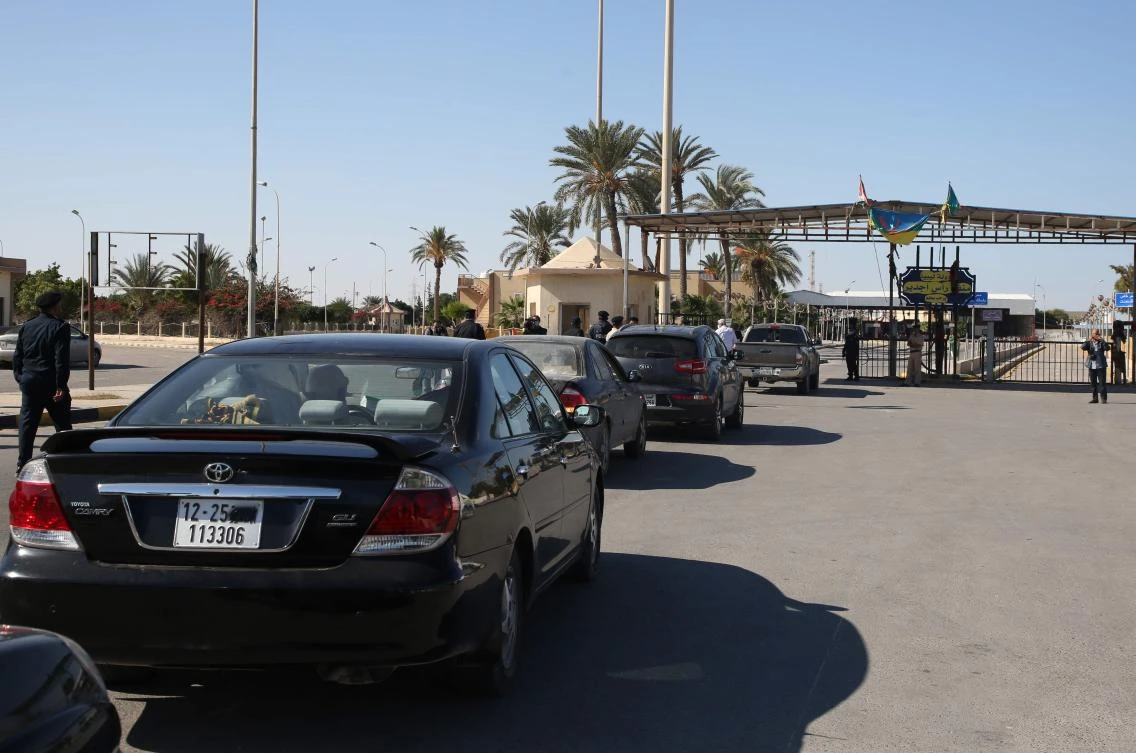 Cars in Libya cross to neighbouring Tunisia via the Ras Jedir border post, after its reopening on November 14, 2020. (AFP)