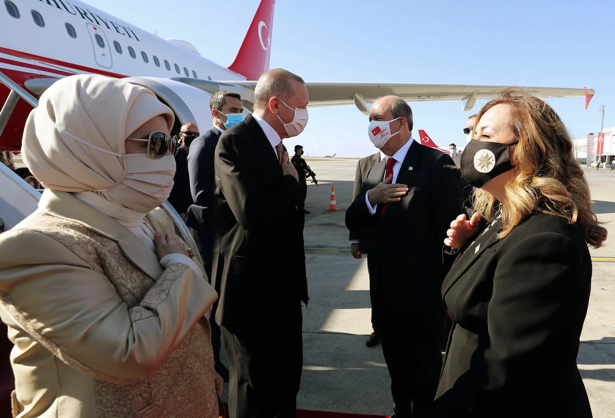 Turkey's President Recep Tayyip Erdogan, left, his wife Emine Erdogan, left, Ersin Tatar, second right, and his wife Sibel Tatar, greet each other during a welcome ceremony at Ercan Airport, in Nicosia, Northern Cyprus, Sunday, Nov. 15, 2020. (AP)
