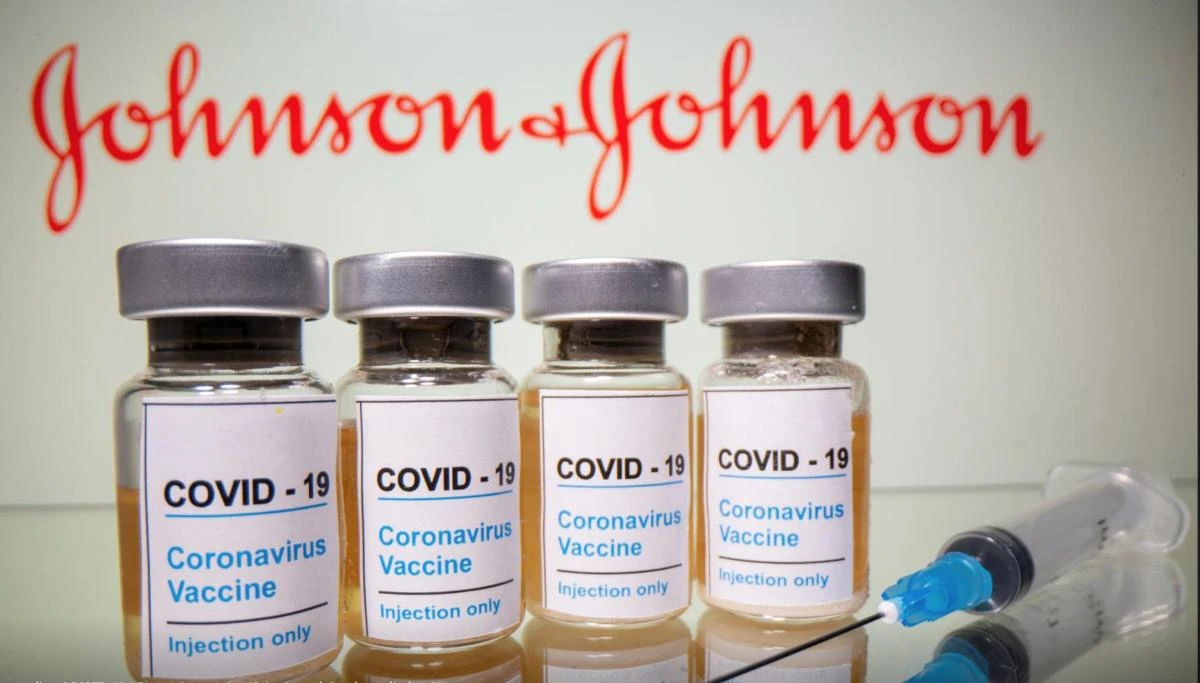 Vials with a sticker reading, "COVID-19 / Coronavirus vaccine / Injection only" and a medical syringe are seen in front of a displayed Johnson & Johnson logo in this illustration taken October 31, 2020. (Reuters)