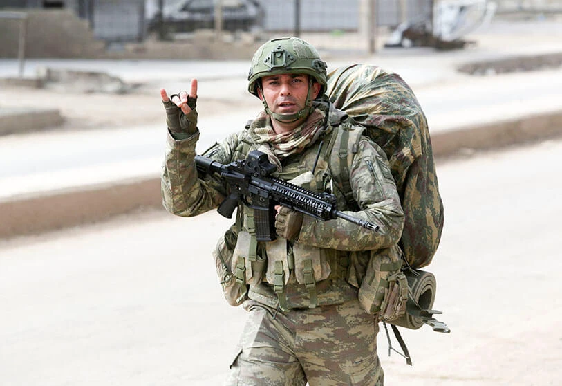 A Turkish soldier flashes the symbol of the Grey Wolves, a far-right ultra-nationalist Turkish organization, in Atareb, Aleppo province, Syria, 19 February, 2020. (AFP)