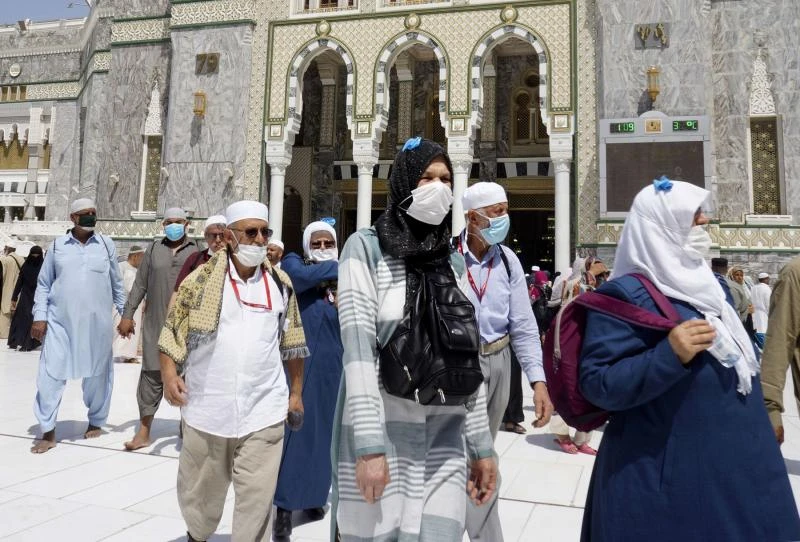 Muslim worshippers wear masks after the noon prayers outside the Grand Mosque, in the Muslim holy city of Mecca, Saudi Arabia, Saturday, March 7. (AP)