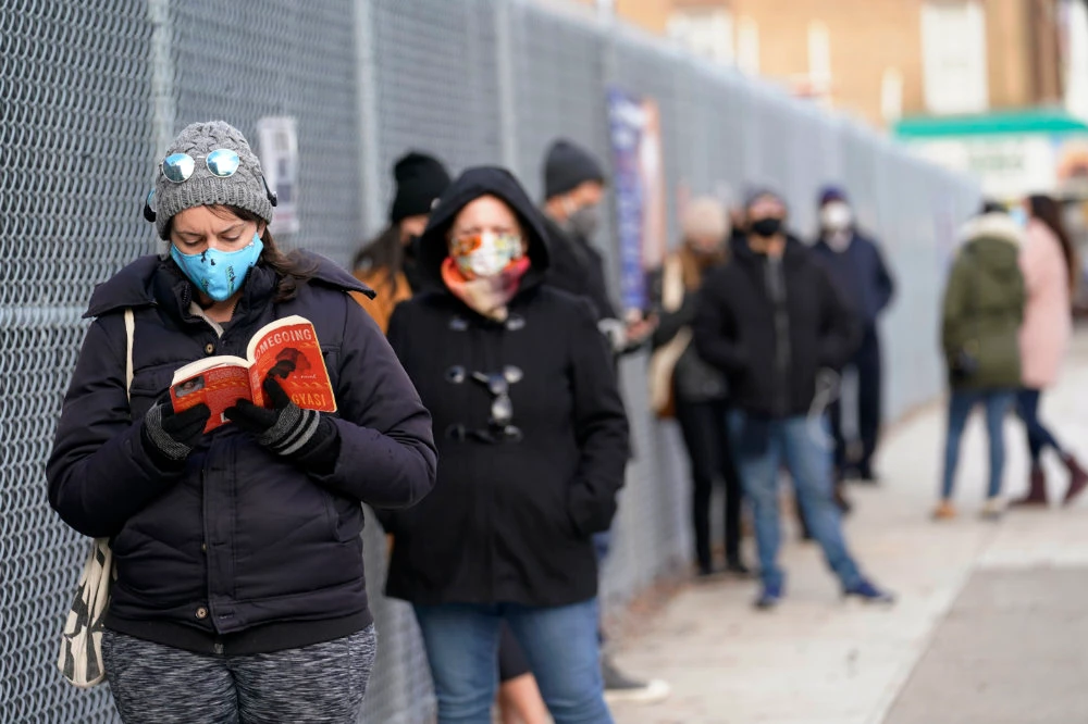 Residents queue outside a New York City Health + Hospitals COVID testing site in the Brooklyn borough of New York on Nov. 19, 2020. (AP Photo/Kathy Willens)