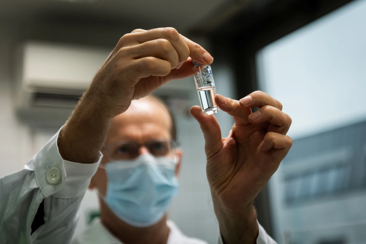 Laboratory assistant holds a tube with Russia's "Sputnik-V" vaccine against the coronavirus disease (COVID-19) at the National Institute of Pharmacy and Nutrition in Budapest. (Reuters)