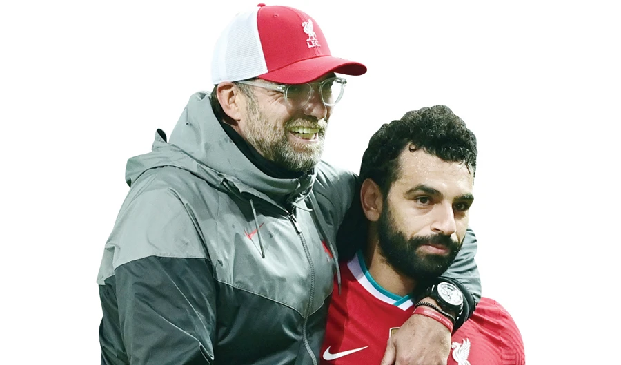 Liverpool’s manager Jurgen Klopp with Liverpool’s midfielder Mohamed Salah. (File/AFP)