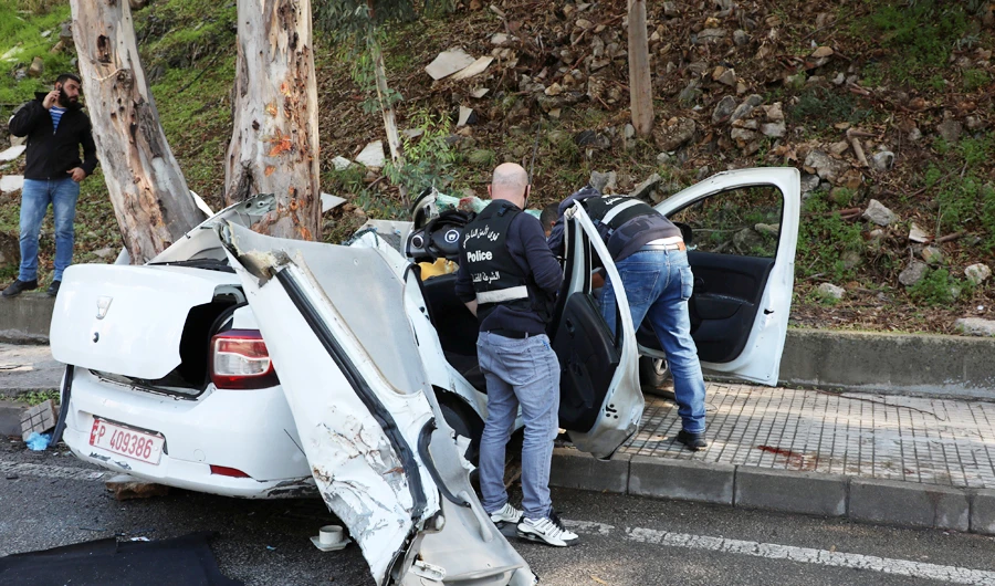 Members of the Lebanese police inspect the damaged car in Hadath, Lebanon, November 21, 2020. (REUTERS)