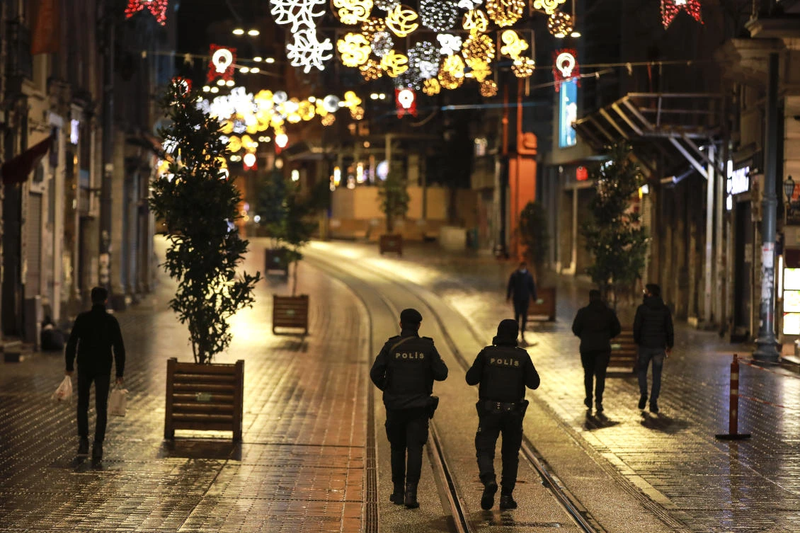 Police officers patrol Istiklal street, the main shopping street in Istanbul, minutes into the lockdown, part of the new measures to try curb the spread of the coronavirus, Saturday, Nov. 21, 2020. (AP)