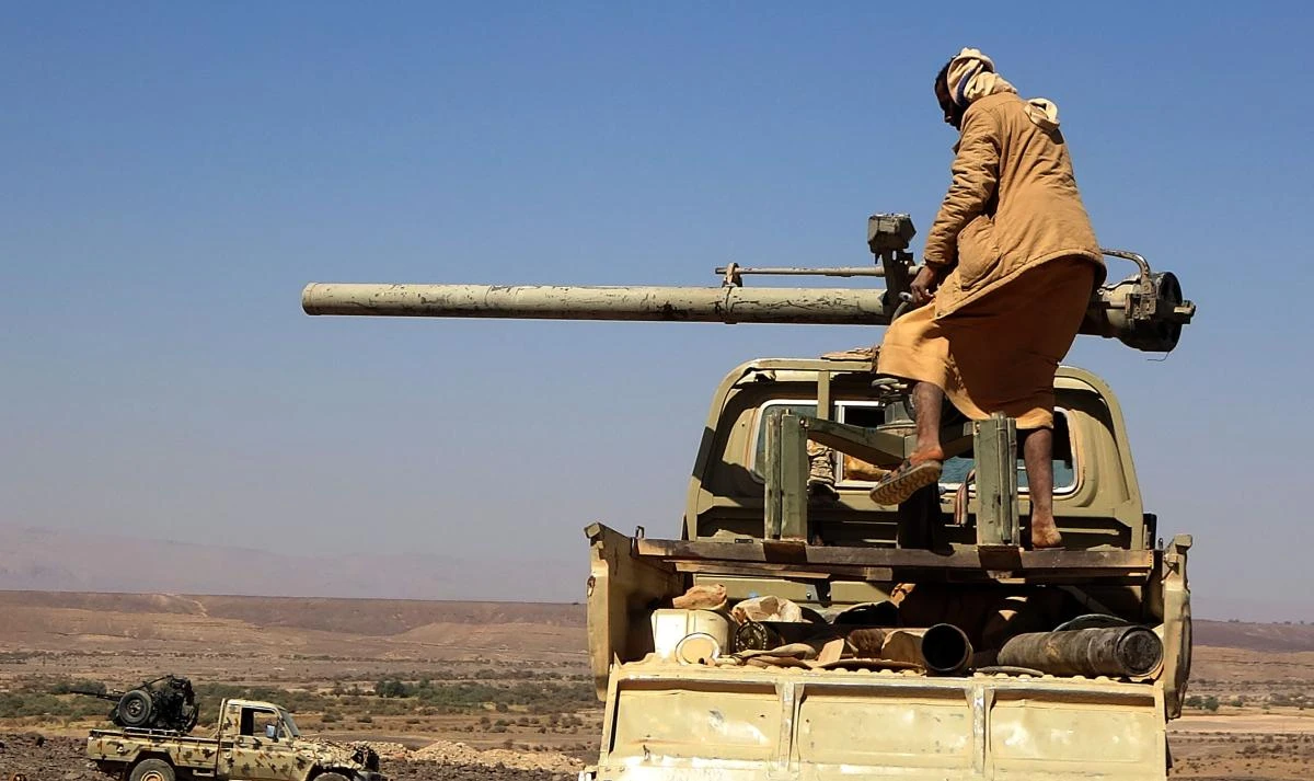 A combatant mans a recoilless gun as forces loyal to Yemen's Saudi-backed government clash with Huthi rebel fighters around the strategic government-held "Mas Camp" military base, in al-Jadaan area about 50 kilometres northwest of Marib in central Yemen, on November 22, 2020. (AFP)