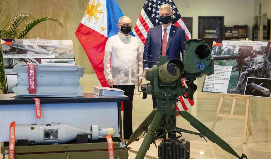US National Security Advisor Robert O'Brien (R) and Philippine Foreign Minister Teodoro Locsin (L) pose with precision-guided munitions among other defence articles during a turnover ceremony at the Department of Foreign Affairs office in Manila on November 23, 2020. (AFP)