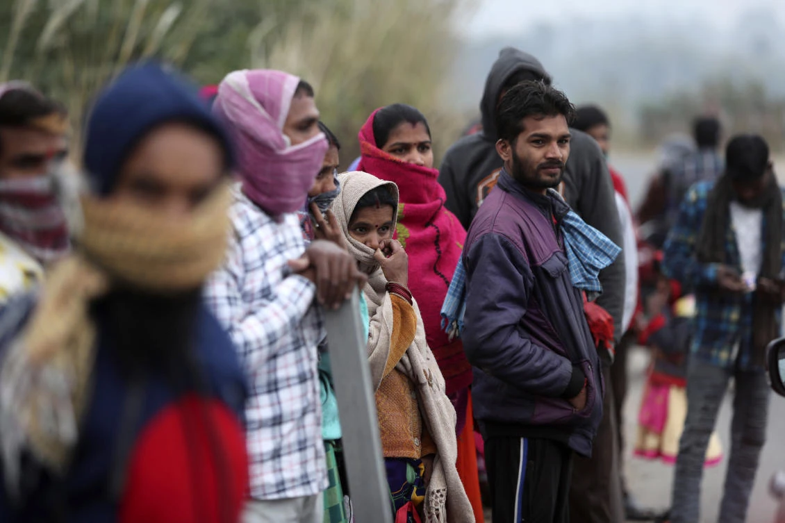 Migrant laborers from other states looking for work gather on a street on the outskirts of Jammu, India on Nov. 23, 2020. (AP)