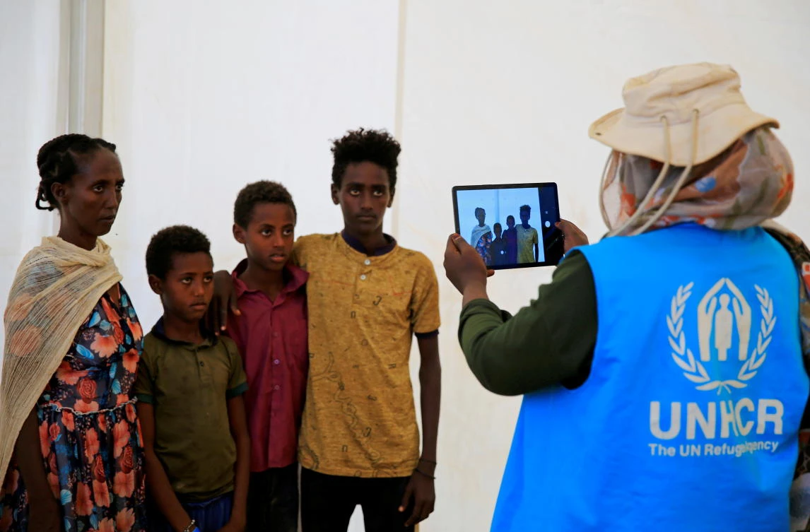 A humanitarian worker from UNHCR, documents Ethiopian refugees fleeing from the ongoing fighting in Tigray region, at the Um-Rakoba camp, on the Sudan-Ethiopia border, in the Al-Qadarif state, Sudan November 23, 2020. (Reuters)