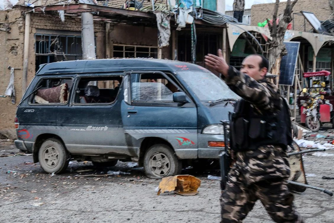 Afghan security personnel arrive at a site after two blasts ripped through in the city of Bamiyan on Tuesday. (AFP)