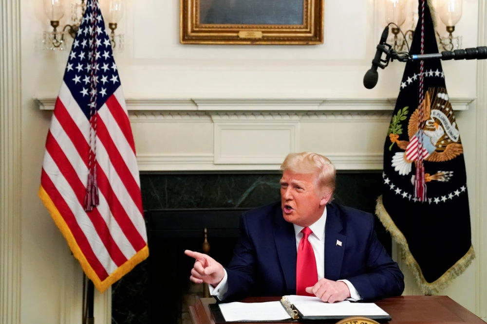 US President Donald Trump gestures as he participates in a Thanksgiving video teleconference with members of the military forces at the White House in Washington on Nov. 26, 2020. (REUTERS/Erin Scott)