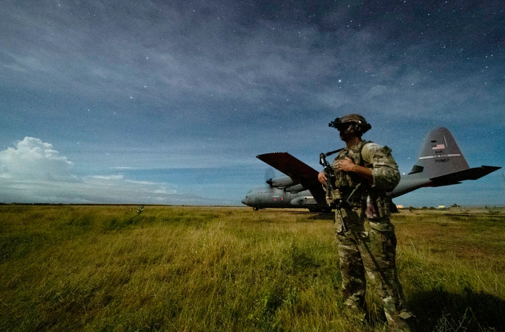A US Army soldier provides security for a C-130J Super Hercules during unloading operations at an unidentified location in Somalia onJune 28, 2020. (US Combined Joint Task Force - Horn of Africa via AP)