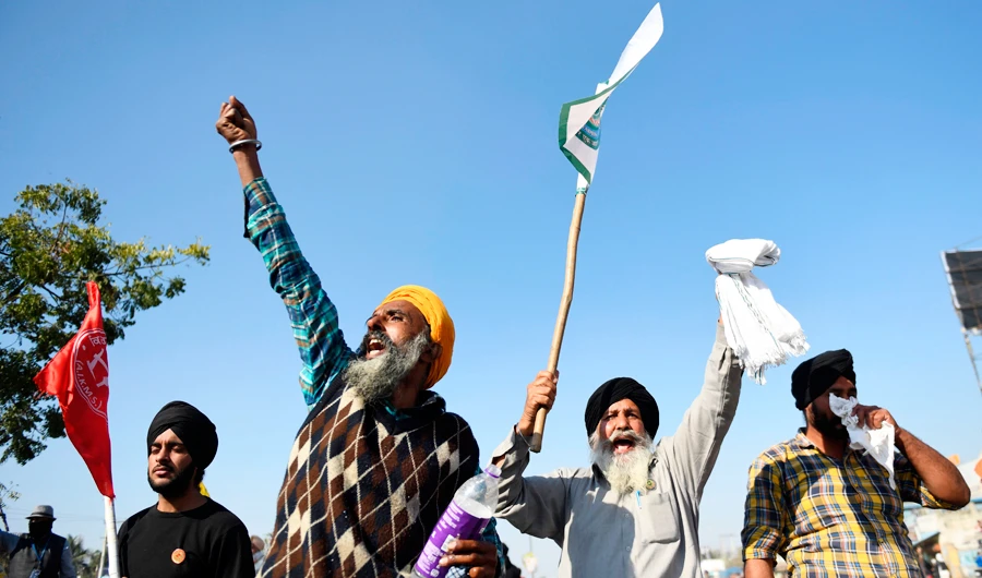 Farmers shout slogans after police blocked them from marching to New Delhi to protest against the central government's recent agricultural reforms at the Delhi-Haryana border in Kundli on November 27, 2020. (AFP)