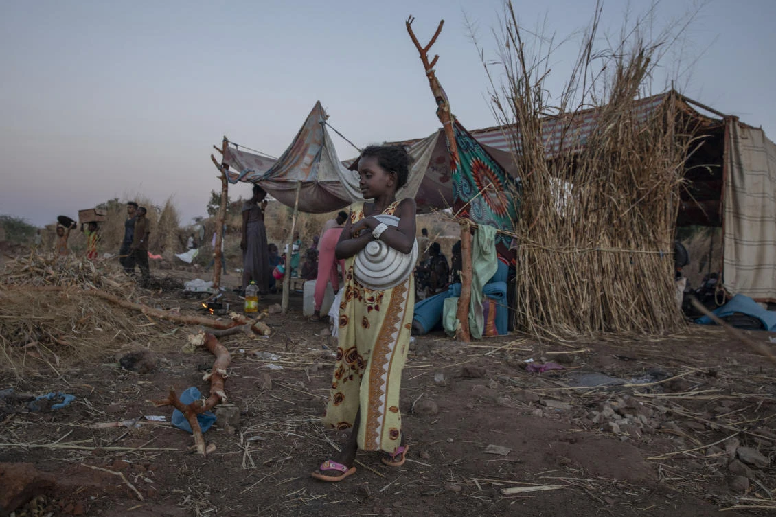 A Tigray girl who fled the conflict in Ethiopia's Tigray region, walks near her shelter in Umm Rakouba refugee camp in Qadarif, eastern Sudan, Wednesday, Nov. 25, 2020. (AP)