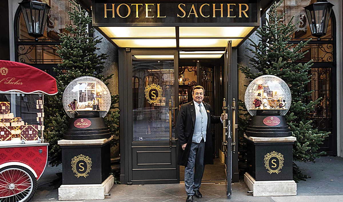 Concierge Uwe Kotzendorfer keeps the proud traditions of Vienna alive, selling Sacher Torte from his two-wheel cart outside the Hotel Sacher. (AFP)