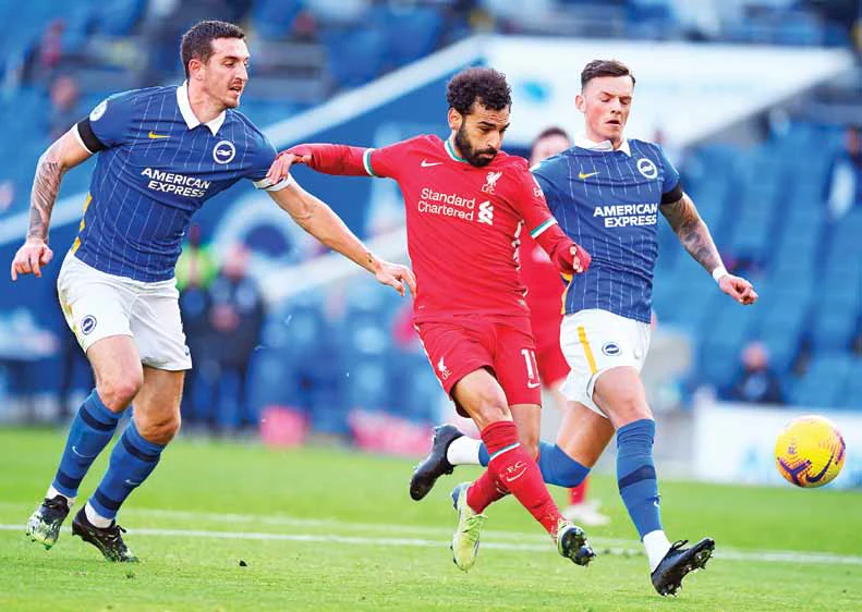 Liverpool’s Mohamed Salah kicks the ball during Saturday’s English Premier League match against Brighton and Hove Albion in England. (AP)