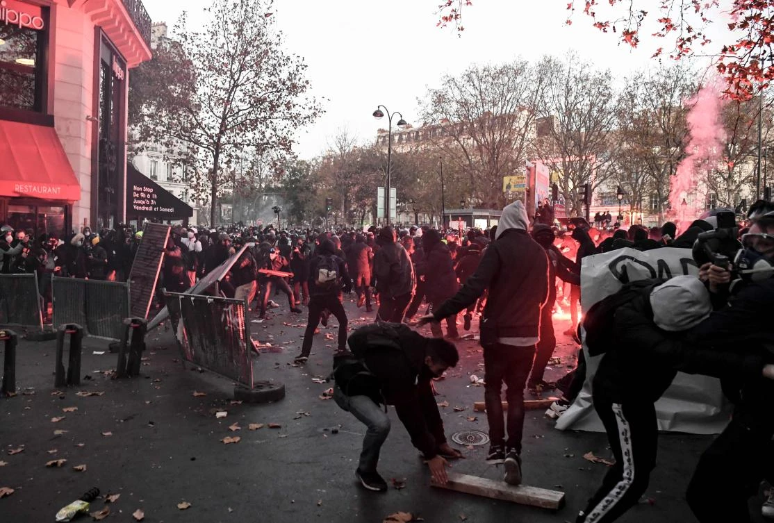 Demonstrators clash with French riot police during a protest against the 'global security' draft law in Paris, on November 28, 2020. (AFP)
