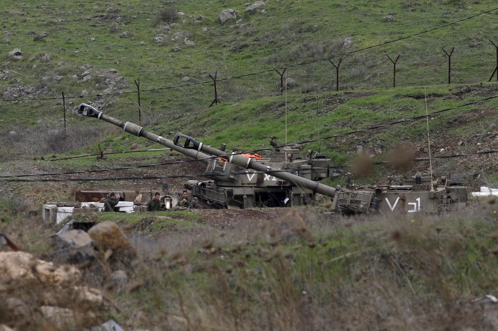 Israeli solders gather next to self-propelled howitzers in the Golan Heights on the border with Syria. (File/AFP)