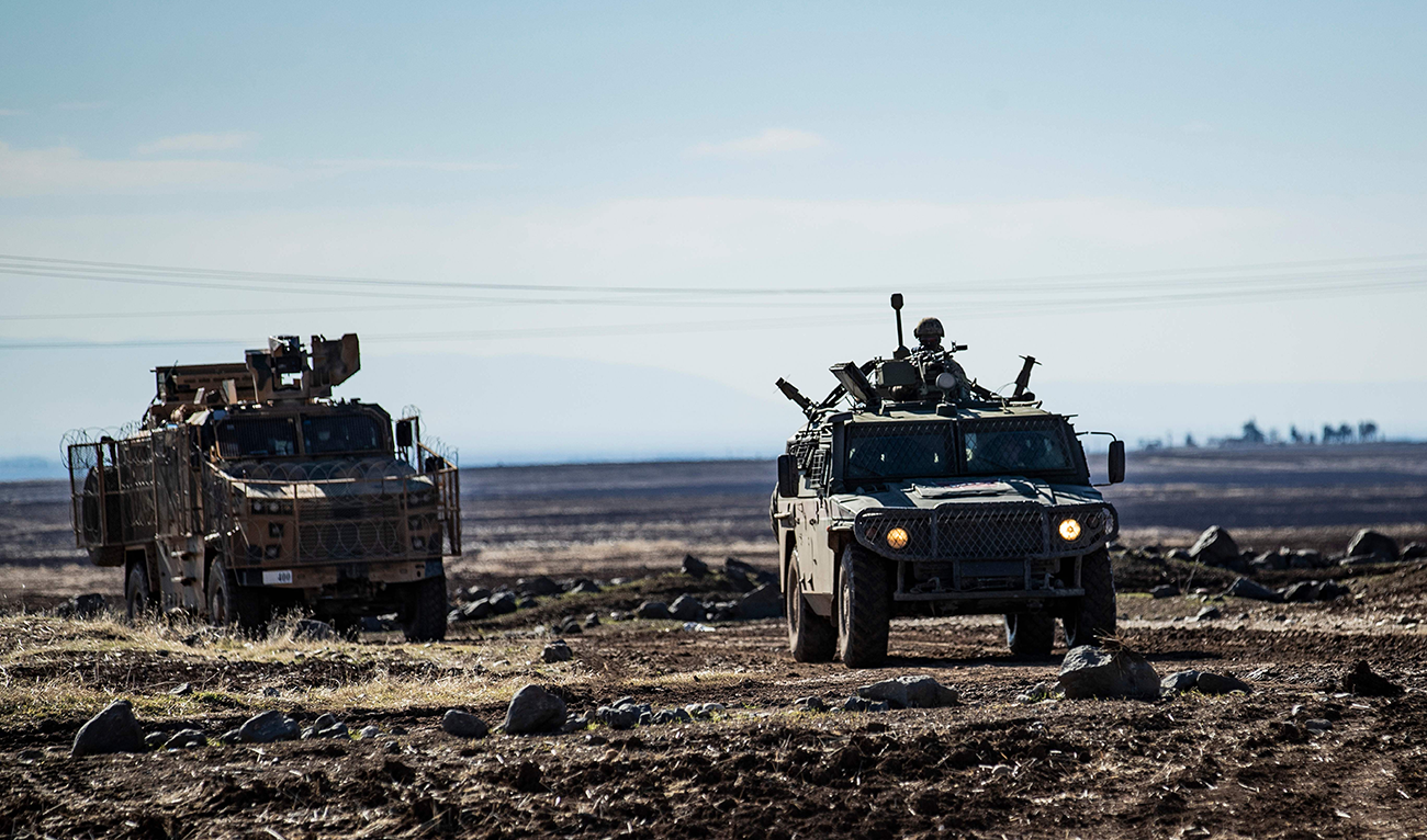 A joint Russian-Turkish patrol advances in the countryside of the Syrian town of Al-Jawadiyah, in the northeastern Hasakeh province, near the border with Turkey, on December 24, 2020. (AFP)