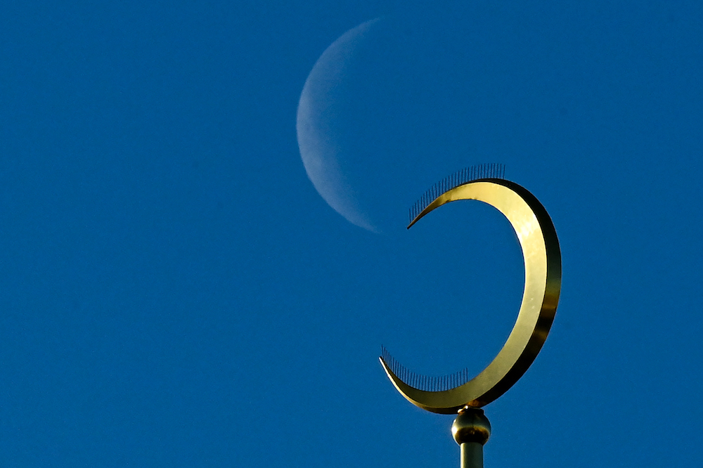 A crescent moon is seen behind Moscow's Sobornaya mosque on December 10, 2020. (AFP)