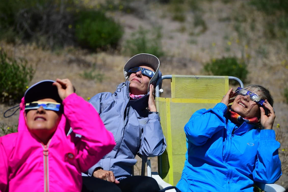 People watch the total solar eclipse in Piedra del Aguila, Neuquen province, Argentina on December 14, 2020.RONALDO SCHEMIDT / AFP