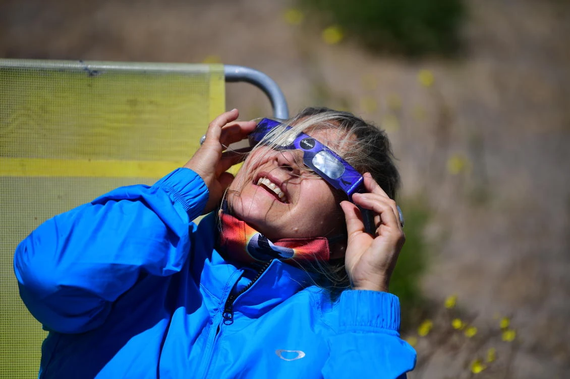 A woman watches the total solar eclipse in Piedra del Aguila, Neuquen province, Argentina on December 14, 2020.RONALDO SCHEMIDT / AFP