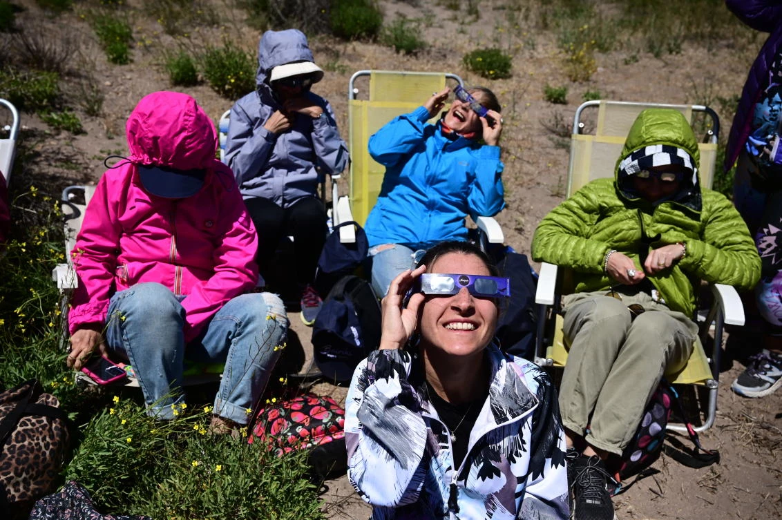 People watch the total solar eclipse in Piedra del Aguila, Neuquen province, Argentina on December 14, 2020.RONALDO SCHEMIDT / AFP