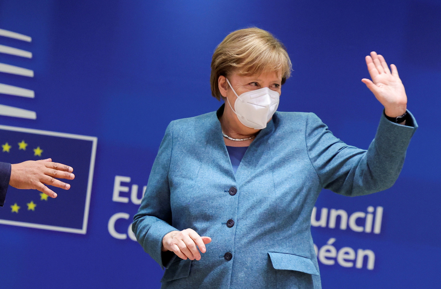 Germany's Chancellor Angela Merkel waves as she attends a round table meeting at a face-to-face EU summit amid the coronavirus disease (COVID-19) lockdown in Brussels, Belgium December 10, 2020. (Reuters)